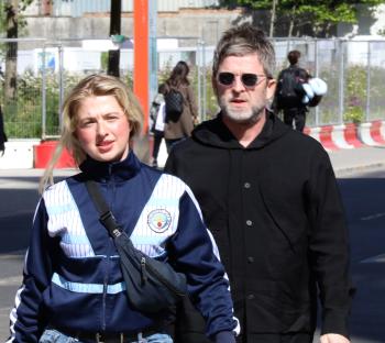 Noel Gallagher and his daughter Anais walking near Wembley Stadium.