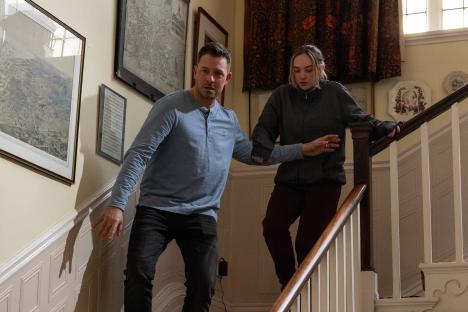 A man and a woman descending a staircase.