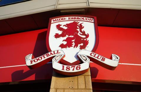 Middlesbrough Football Club emblem on a red building.