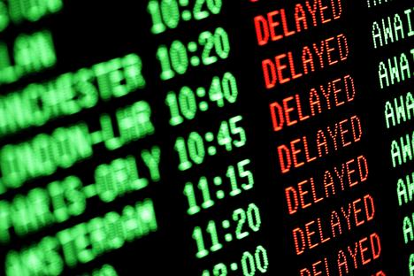 Airport departure board showing multiple flight delays.