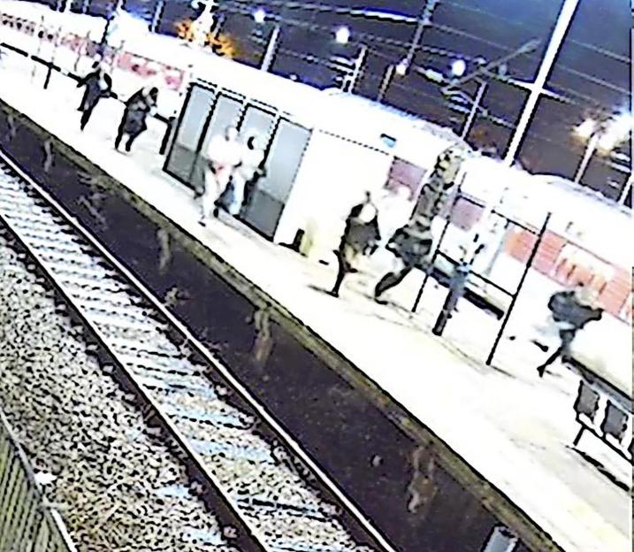 Train station surveillance video showing a knifeman following screaming passengers.