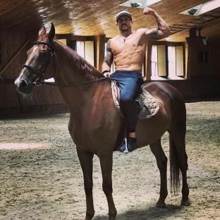 Oleksandr Usyk riding a horse.