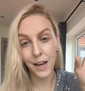 Woman in pajamas discussing not being in school WhatsApp groups.