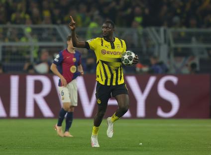 Two Borussia Dortmund soccer players celebrating a goal.