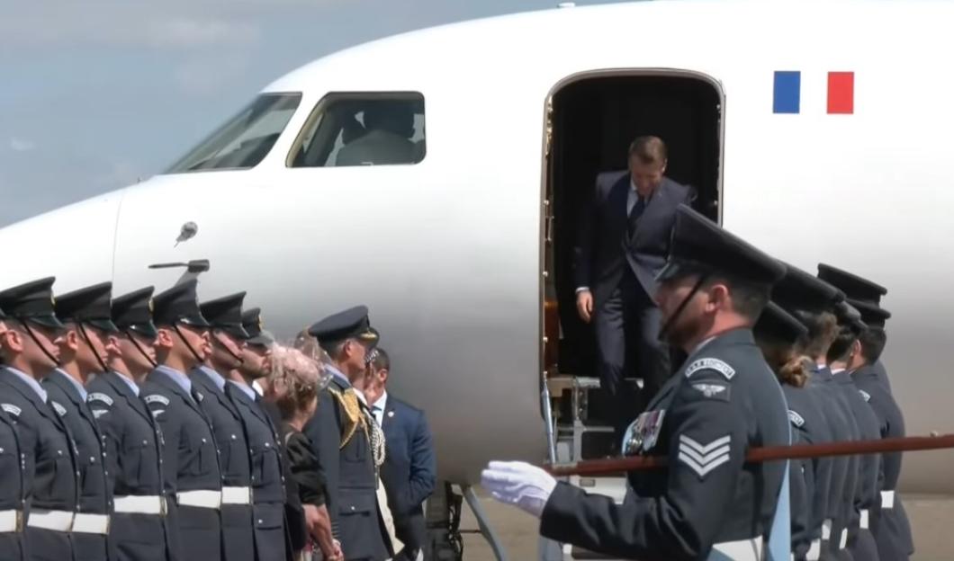 Emmanuel Macron exiting a plane.