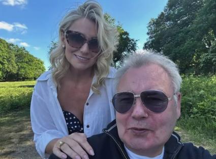 Photo of Eamonn Holmes and his girlfriend Katie Alexander outdoors.