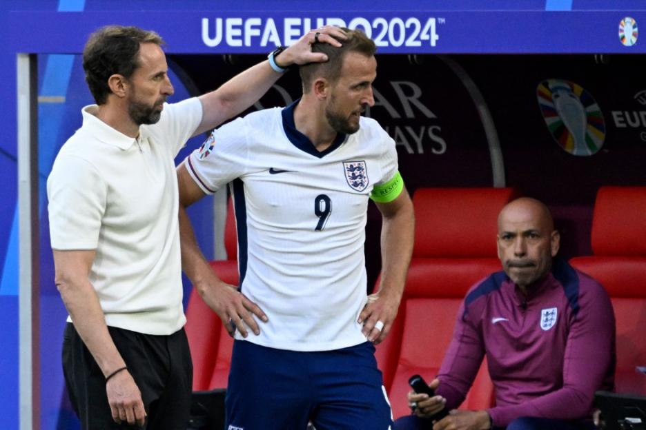 England manager Gareth Southgate touches Harry Kane's head on the sideline.