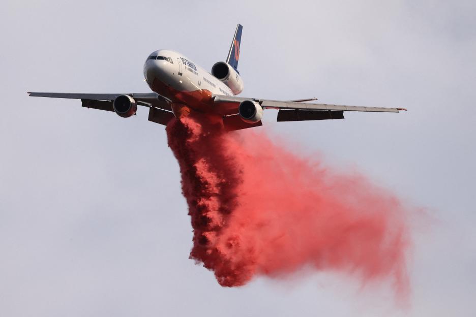 Tanker plane dropping fire retardant.