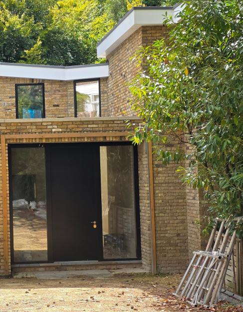 Exterior view of a modern brick house under construction.