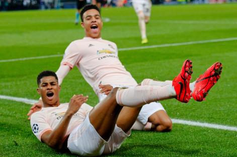 Marcus Rashford slides into celebrate his stoppage-time penalty, clinching a sensational triumph for injury-hit Man Utd