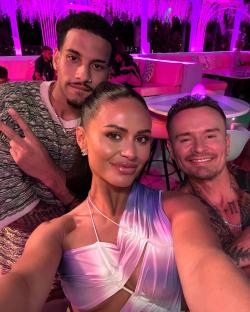 Selfie of three people at a bar.