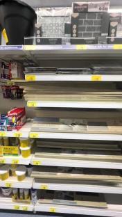 Bathroom tile and flooring options on store shelves.