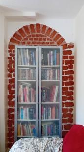 Bookcase with faux brick archway.