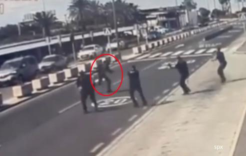 Police officers shooting a man at an airport.