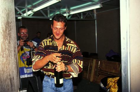 Michael Schumacher opening a bottle of champagne after winning the Formula 1 World Championship.