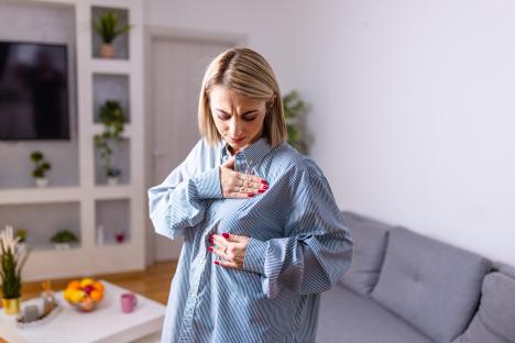 Woman performing a breast self-exam.