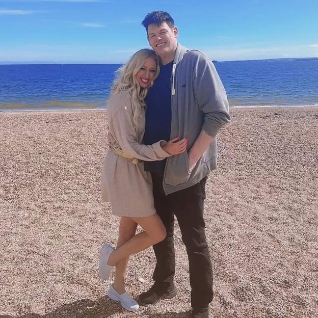 Mark Labbett and Hayley Palmer on a beach.