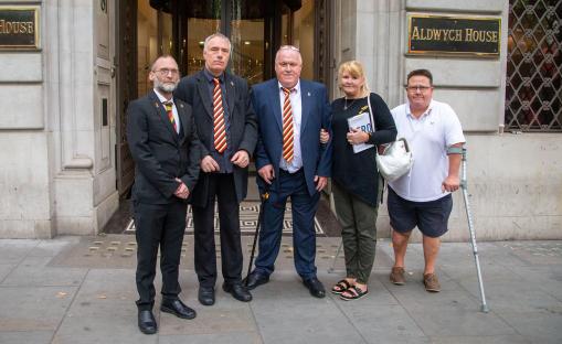 Five victims of the infected blood scandal stand outside Aldwych House.
