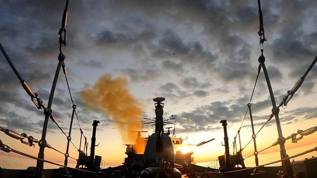 A Naval Strike Missile firing from HMS Somerset at sunset.