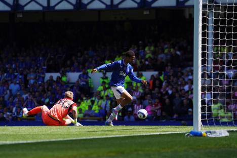 Soccer player scoring a goal.