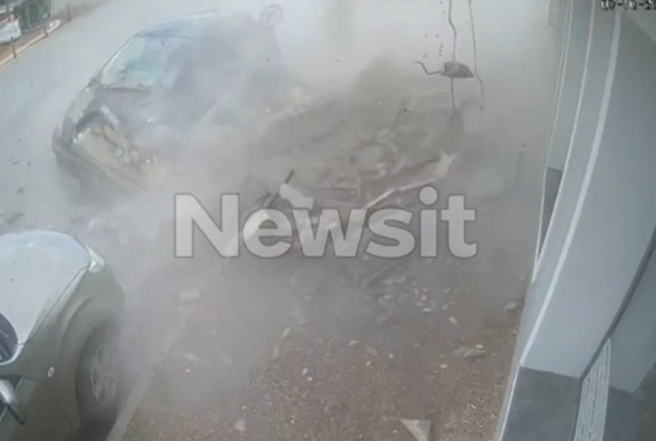 A car in mid-air surrounded by debris and dust after an explosion.