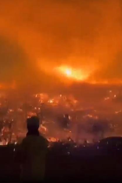 Person watching large wildfire.