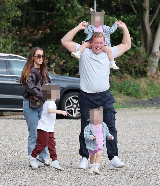 Tom Skinner smiles with wife Sinead and their children.