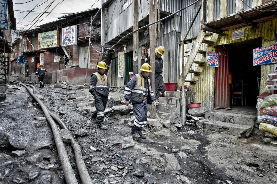 Miners walking on a rocky street in La Rinconada, Peru.