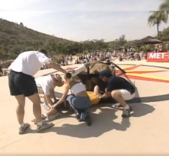 People assisting an injured strongman.