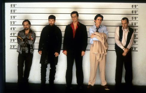 Still image from *The Usual Suspects* showing the five main suspects in a police lineup.
