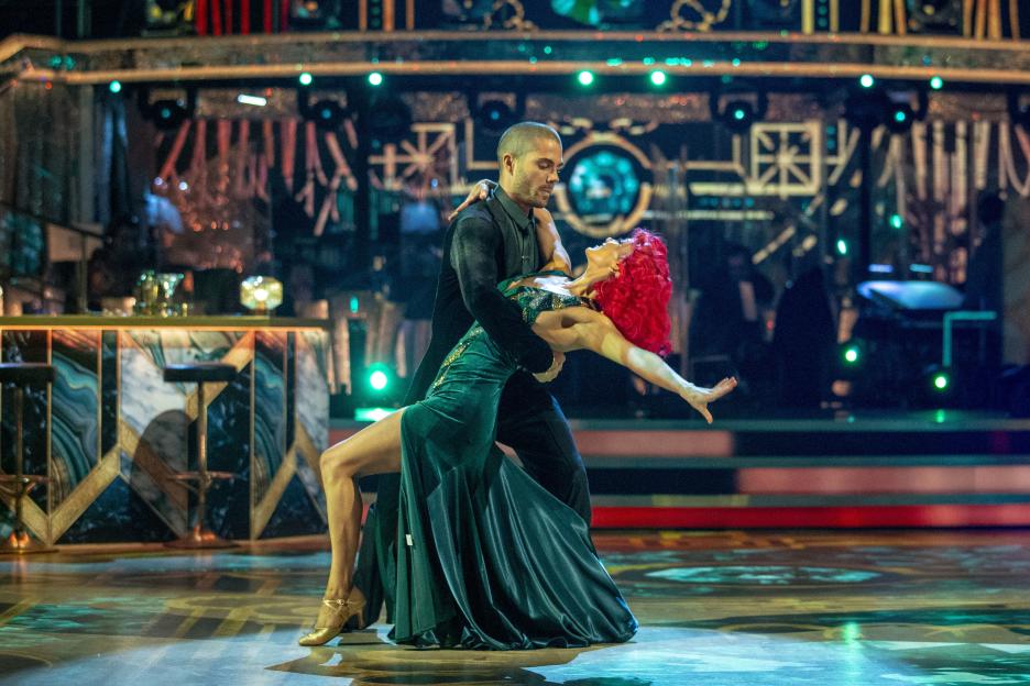 Diane Buswell and Max George dancing during a live show.