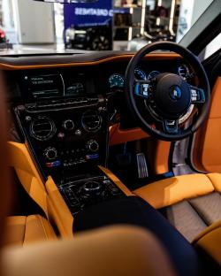 Interior view of a Rolls-Royce's dashboard and seats.