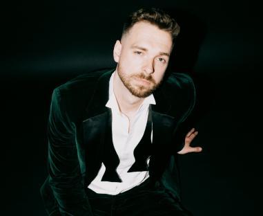 Man in a green velvet suit and bow tie.