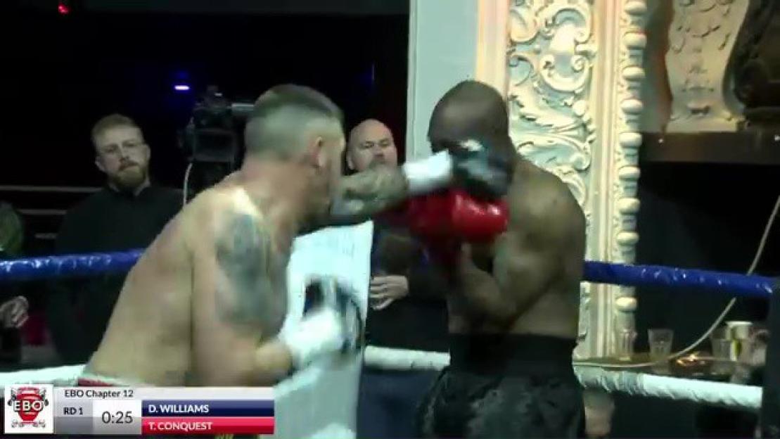 Two male boxers fighting in a ring.