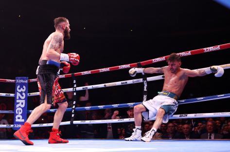 Boxer Leigh Wood is knocked down in a boxing match.