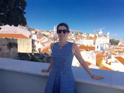 Woman in blue striped dress overlooking Lisbon, Portugal.