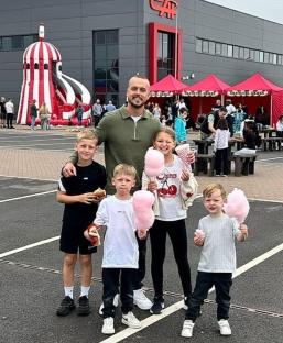 Nathan Osman with his four children at a fair.