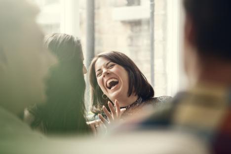 Young people laughing together at a party.