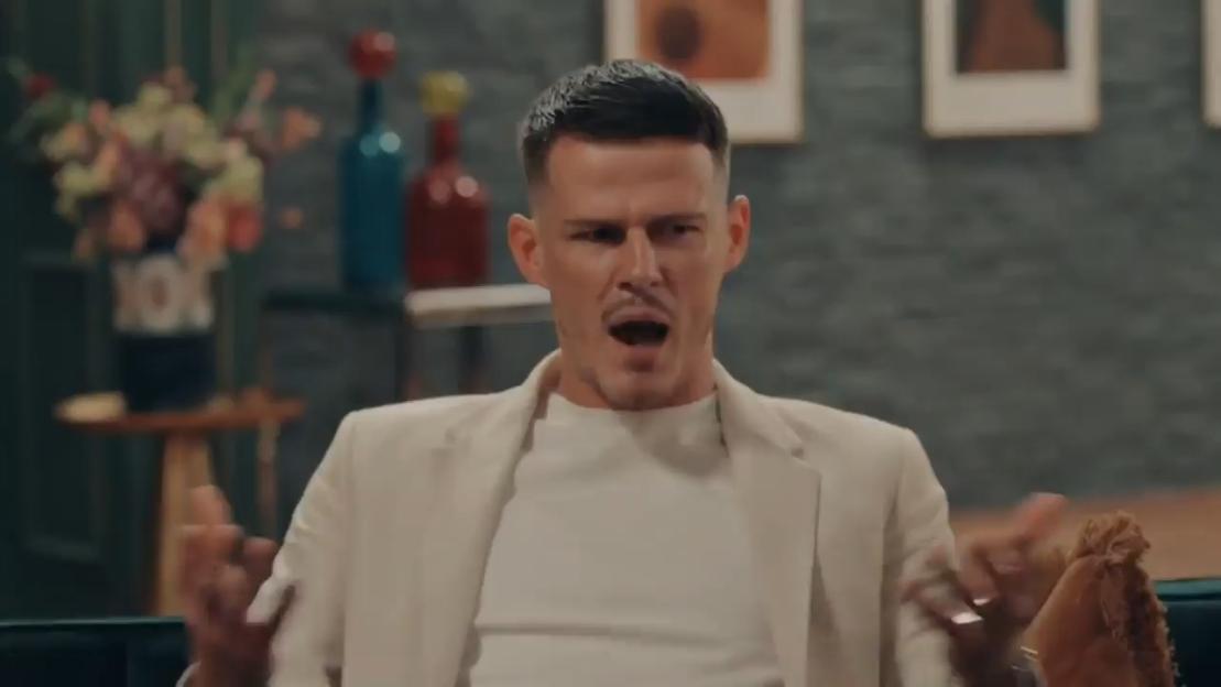 Steven from MAFS, in a white jacket, yelling with his mouth open and hands raised.