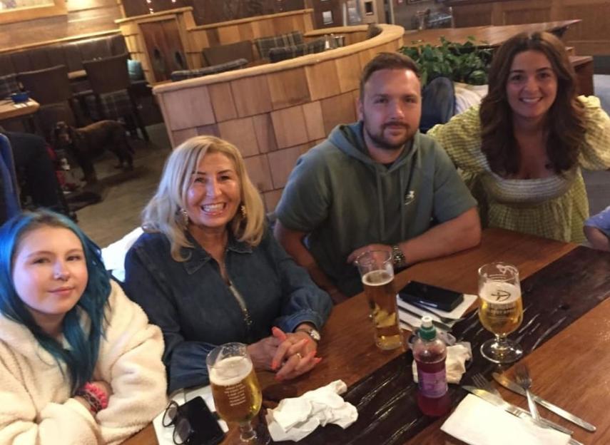 Family sitting at a restaurant table.