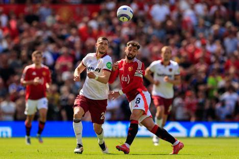 Manchester United and West Ham United players vying for the ball during a Premier League match.