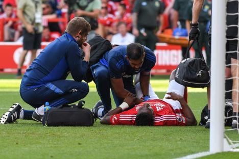 Injured soccer player receiving medical attention on the field.