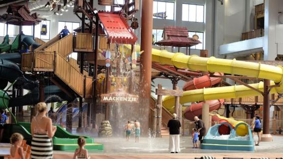 Indoor water park with slides and a large water feature.