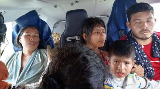 Five survivors of a plane crash in the Amazon, sitting in a vehicle.