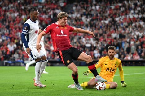 Rasmus Hojlund of Manchester United running with the ball during a soccer match.
