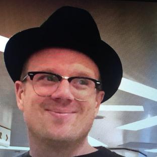 Billy Yates wearing a hat and glasses.