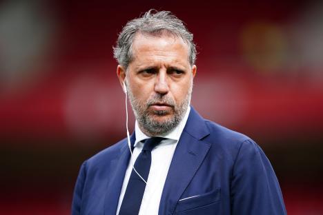 Fabio Paratici, Tottenham Hotspur's managing director of football, wearing a navy suit and white earbuds.