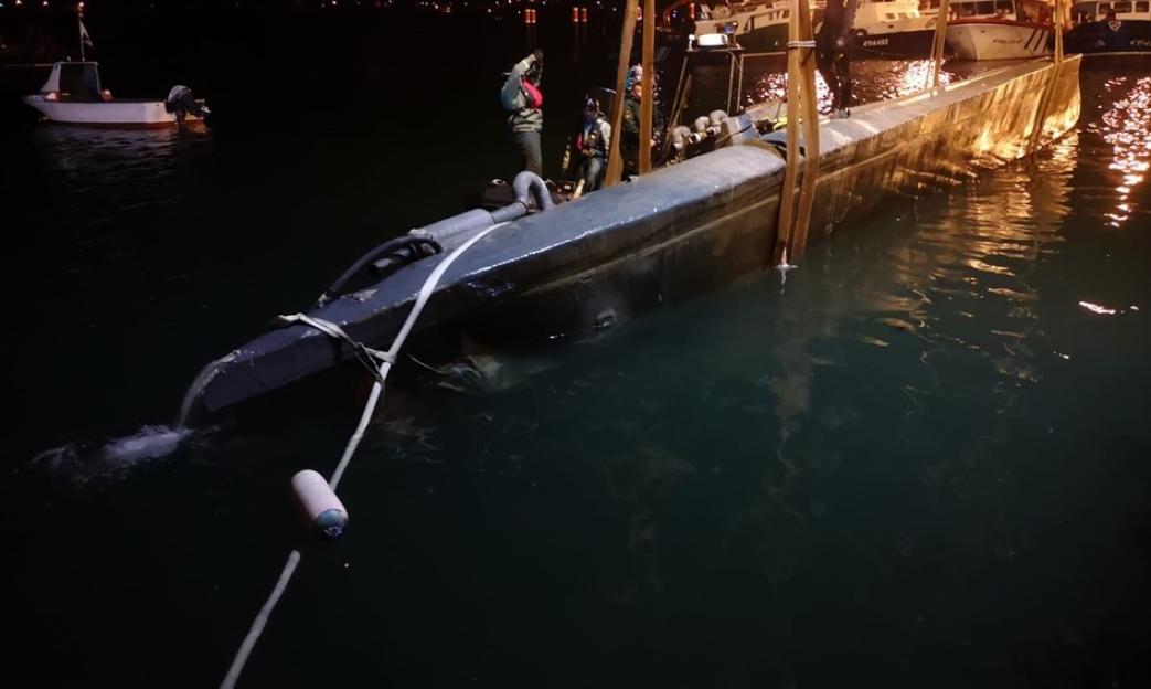 Seized narco-submarine in port.