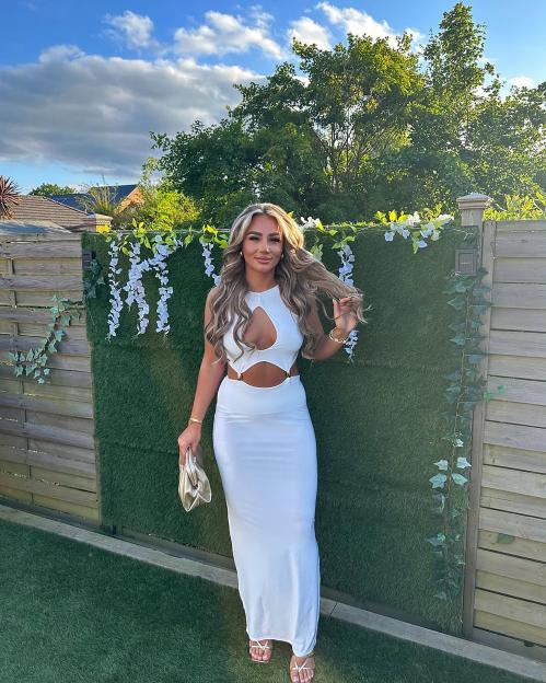 Megan Moore in a white dress.