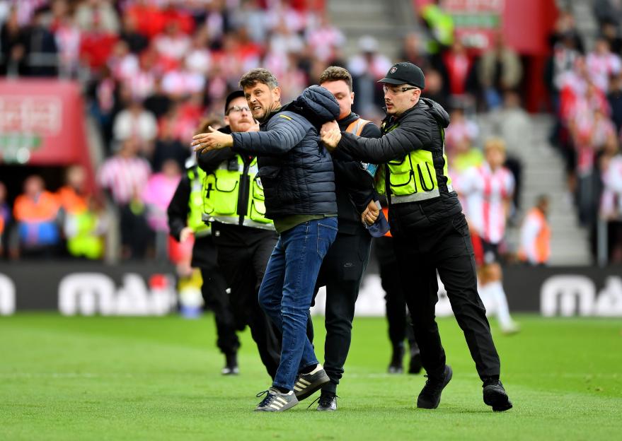 Southampton vs Portsmouth paused as pitch invader evades security before being dragged off by eight police and staff